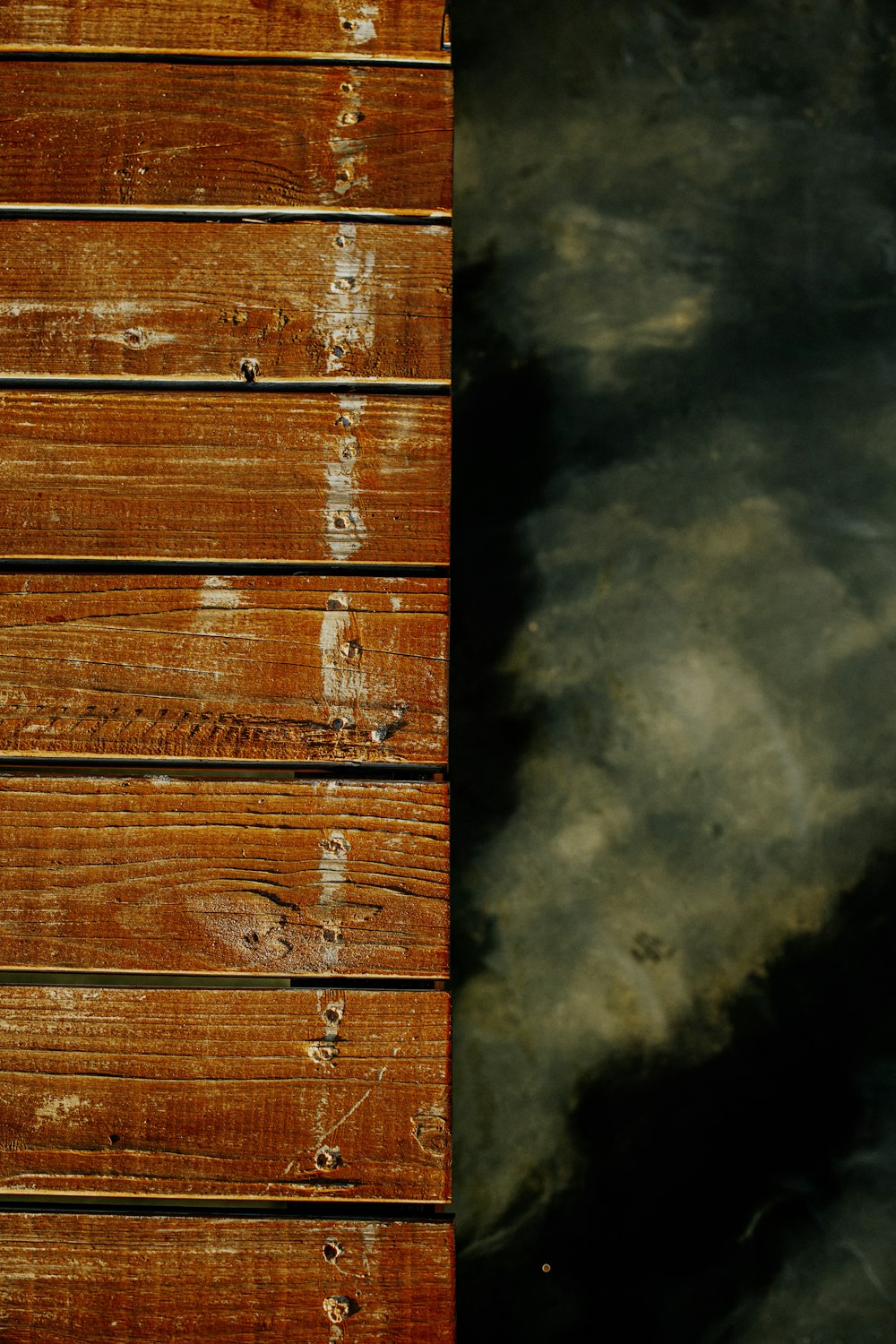 a close up of a wooden dock with water