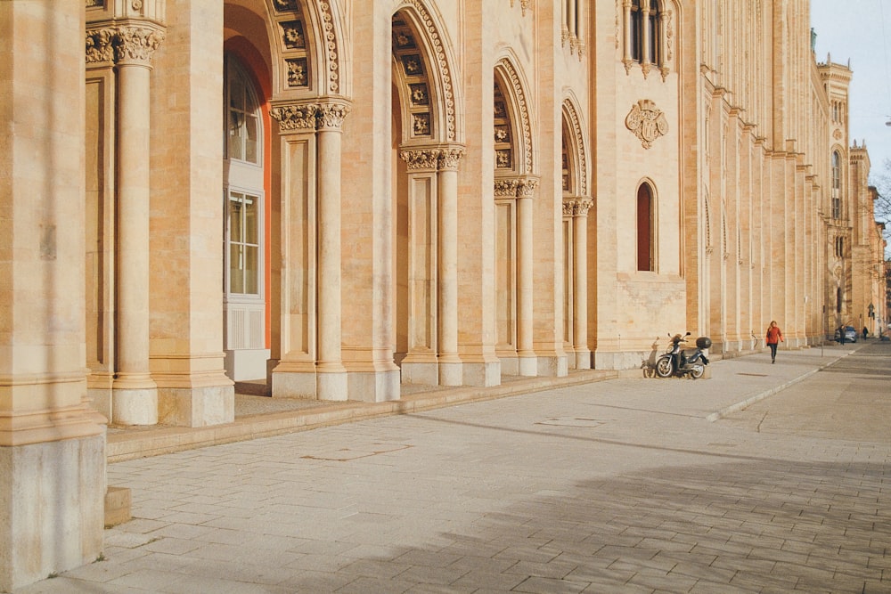 a group of people sitting on a bench in front of a building