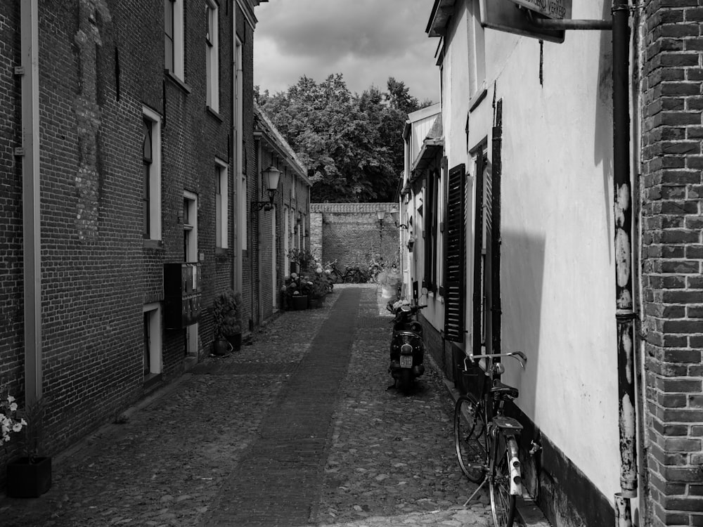 a black and white photo of a narrow street