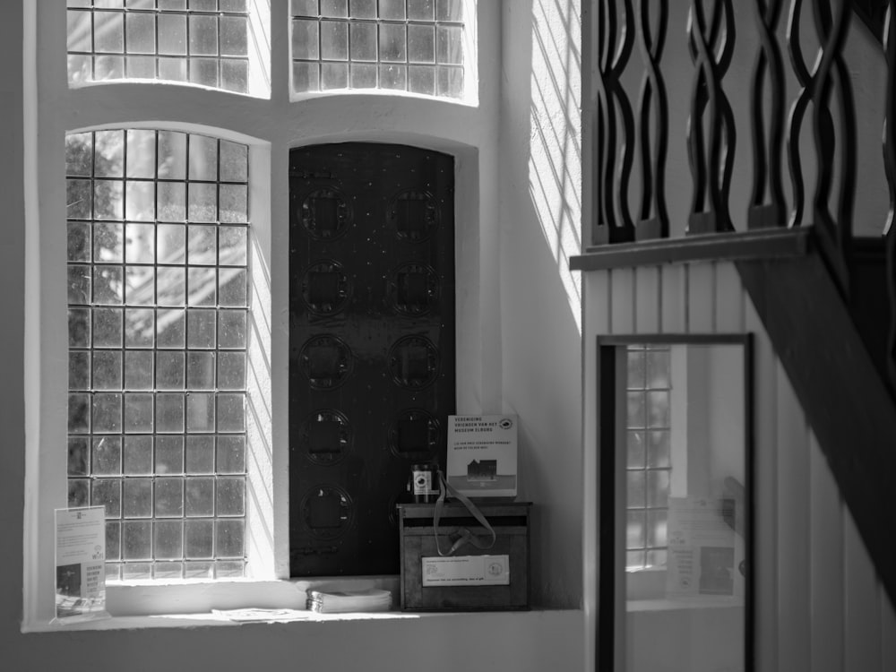 a black and white photo of a window in a house