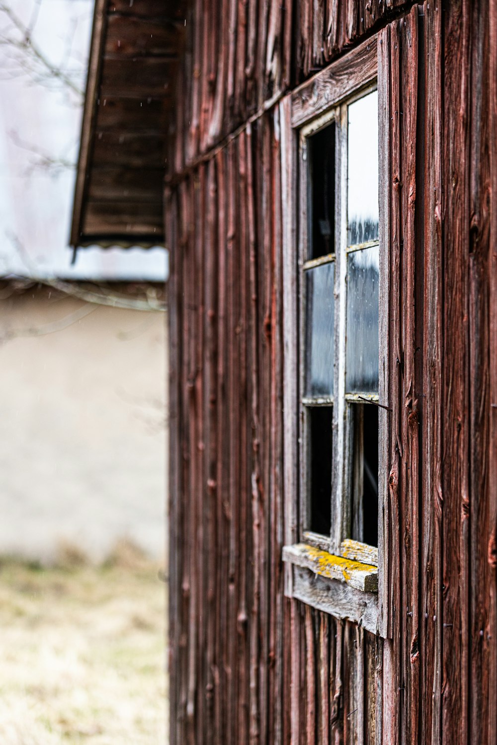 an old wooden building with a broken window