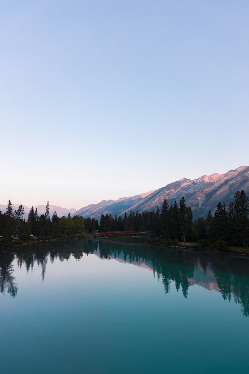 a body of water with mountains in the background