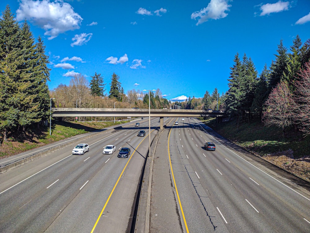 a highway with a bunch of cars driving down it