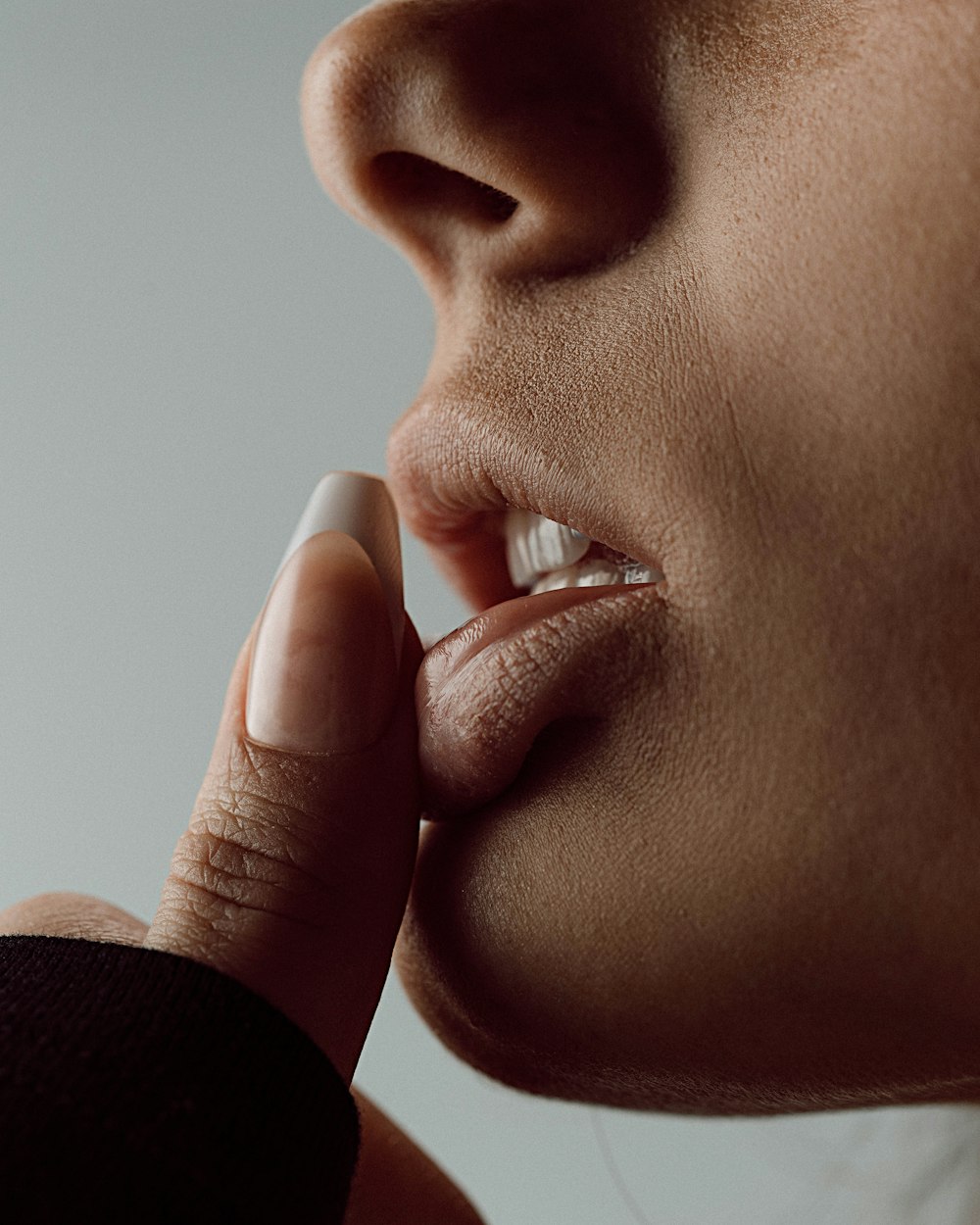 a close up of a person putting something in their mouth