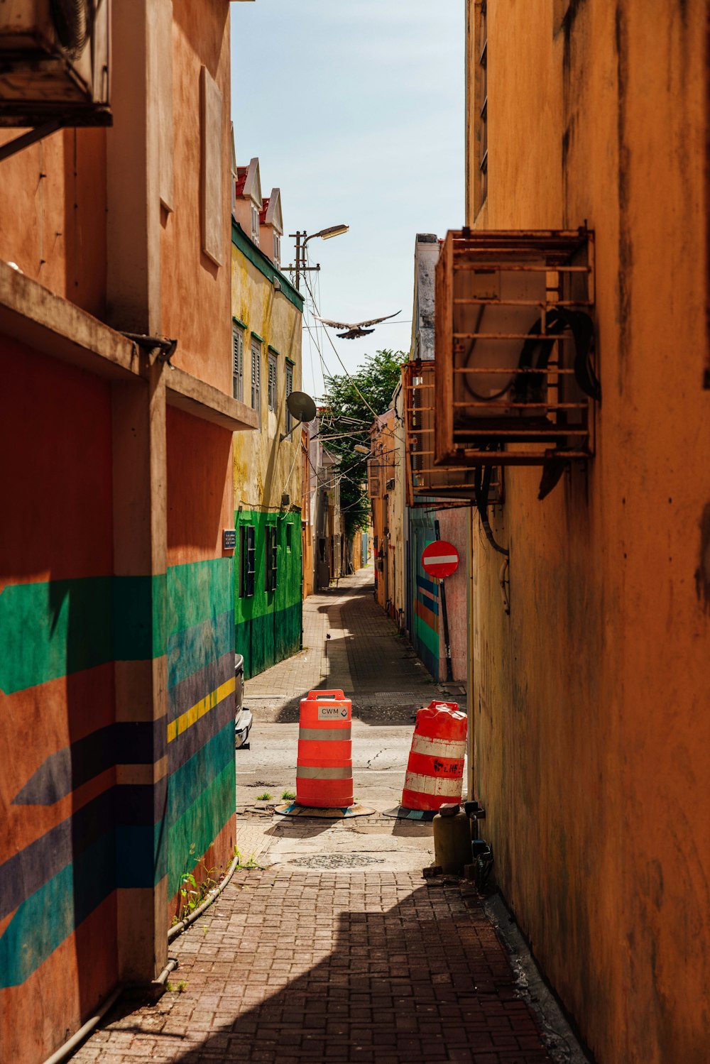 a narrow alley way with traffic cones on either side