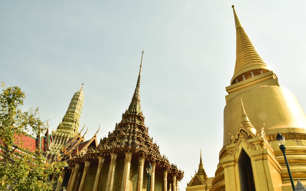 a large golden building with a spire on top of it