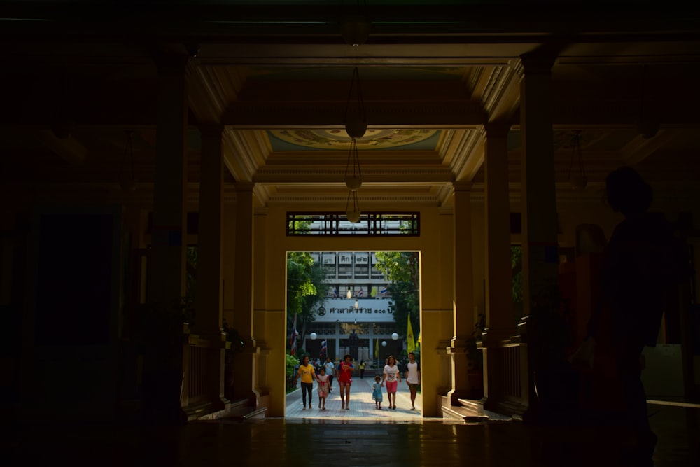 a group of people walking into a building at night