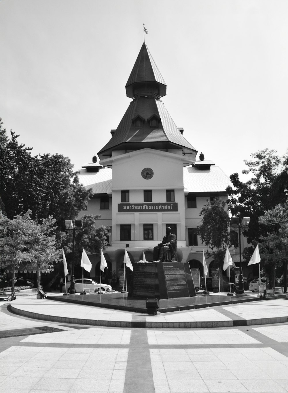 a black and white photo of a building with a clock tower