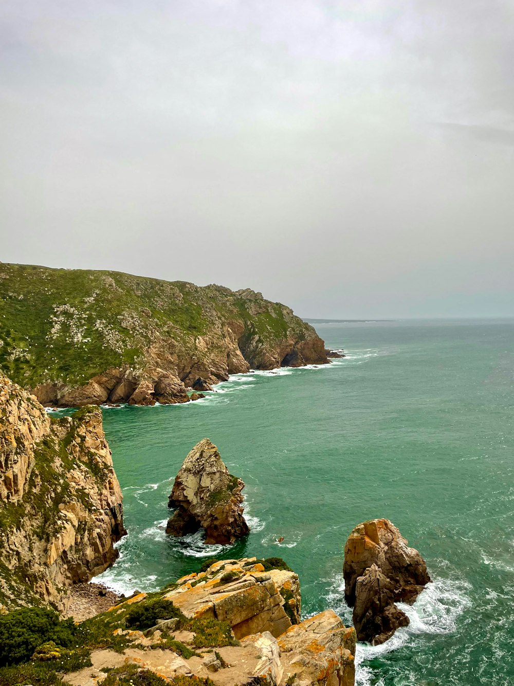 a large body of water near a rocky shore