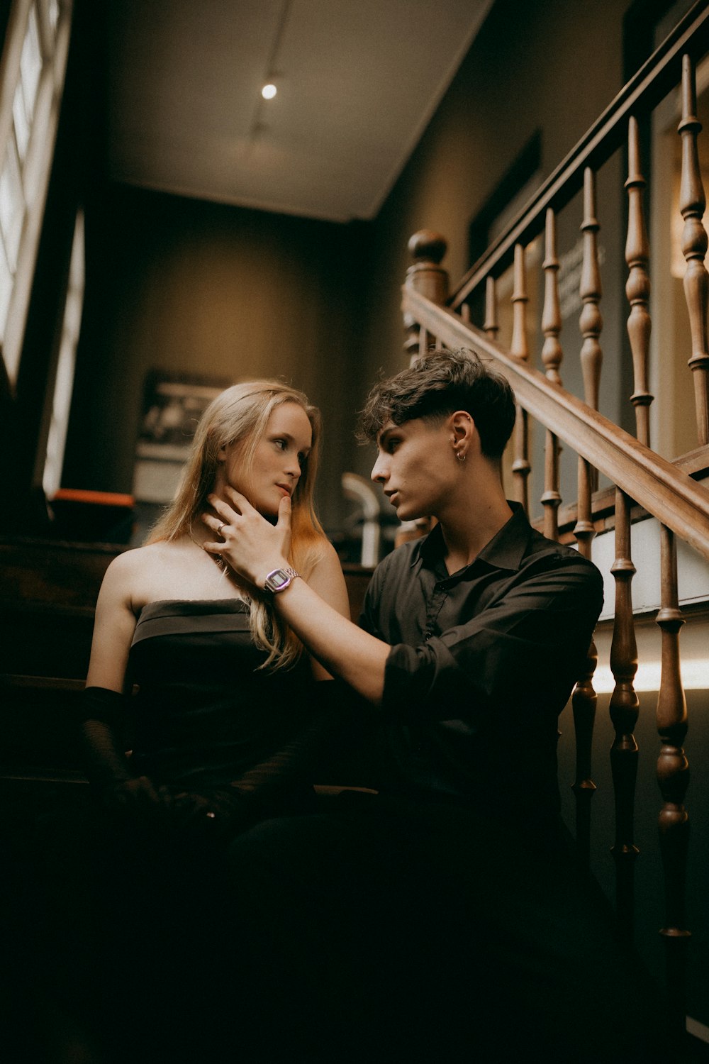 a man sitting next to a woman on a stair case