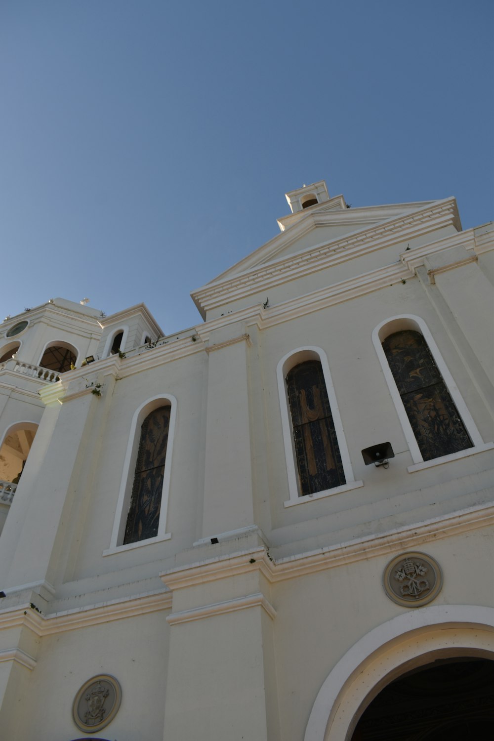 a large white building with a clock on it's side