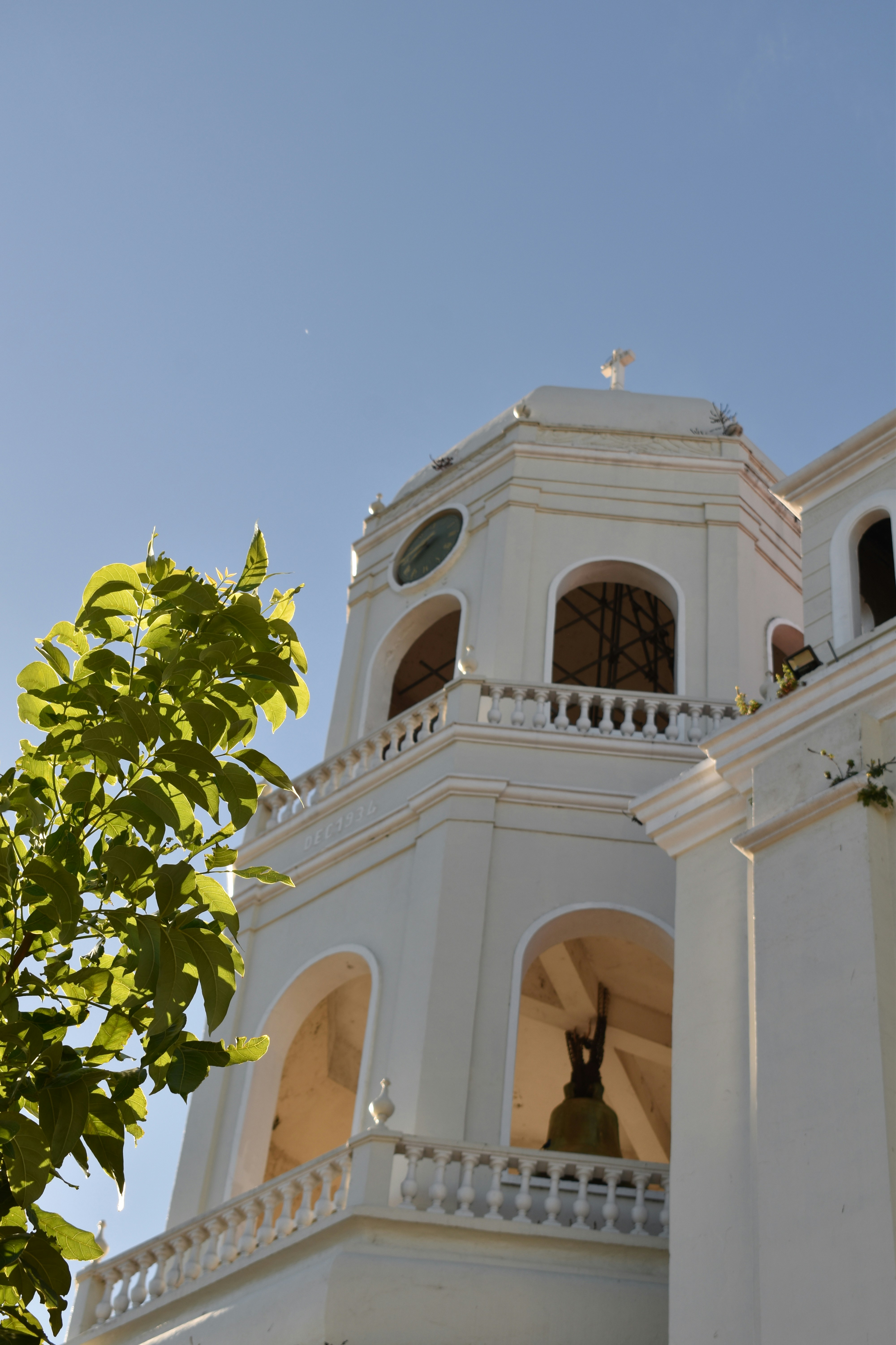 a clock tower with a bell on top of it