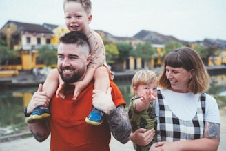 a man holding a little boy on his shoulders