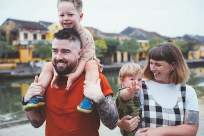 a man holding a little boy on his shoulders