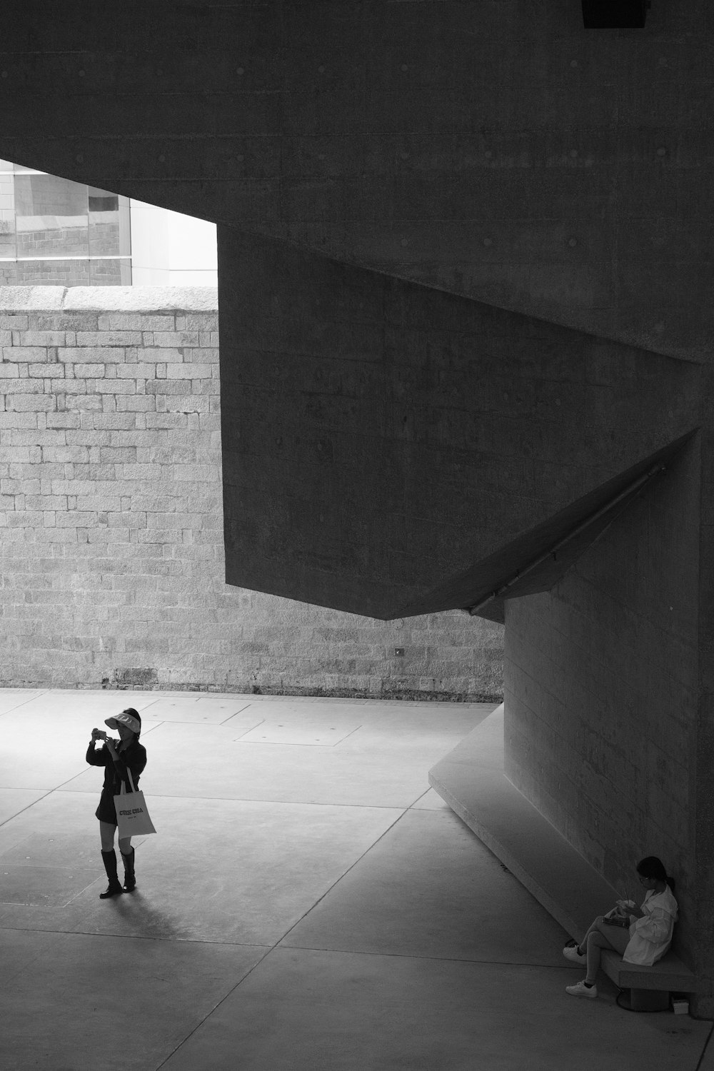 a black and white photo of a person taking a picture