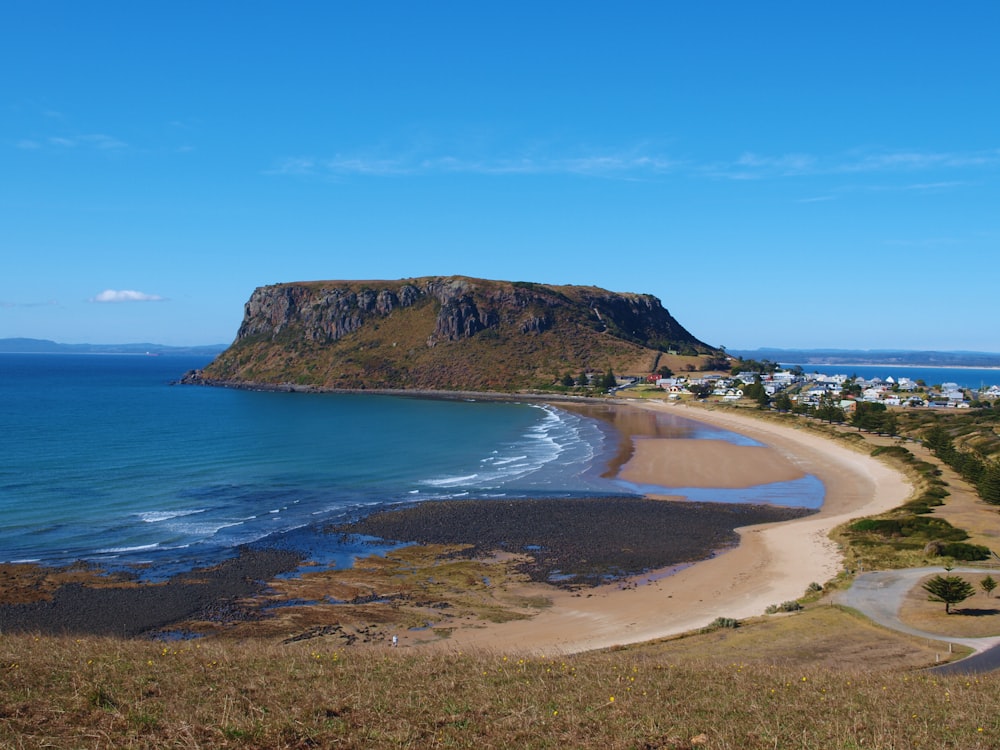 a view of a beach with a mountain in the background