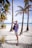 a man standing on a beach next to palm trees