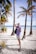 a man standing on a beach next to palm trees