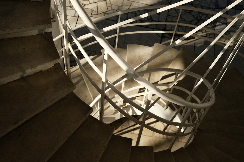 a spiral staircase in a building with a stone floor