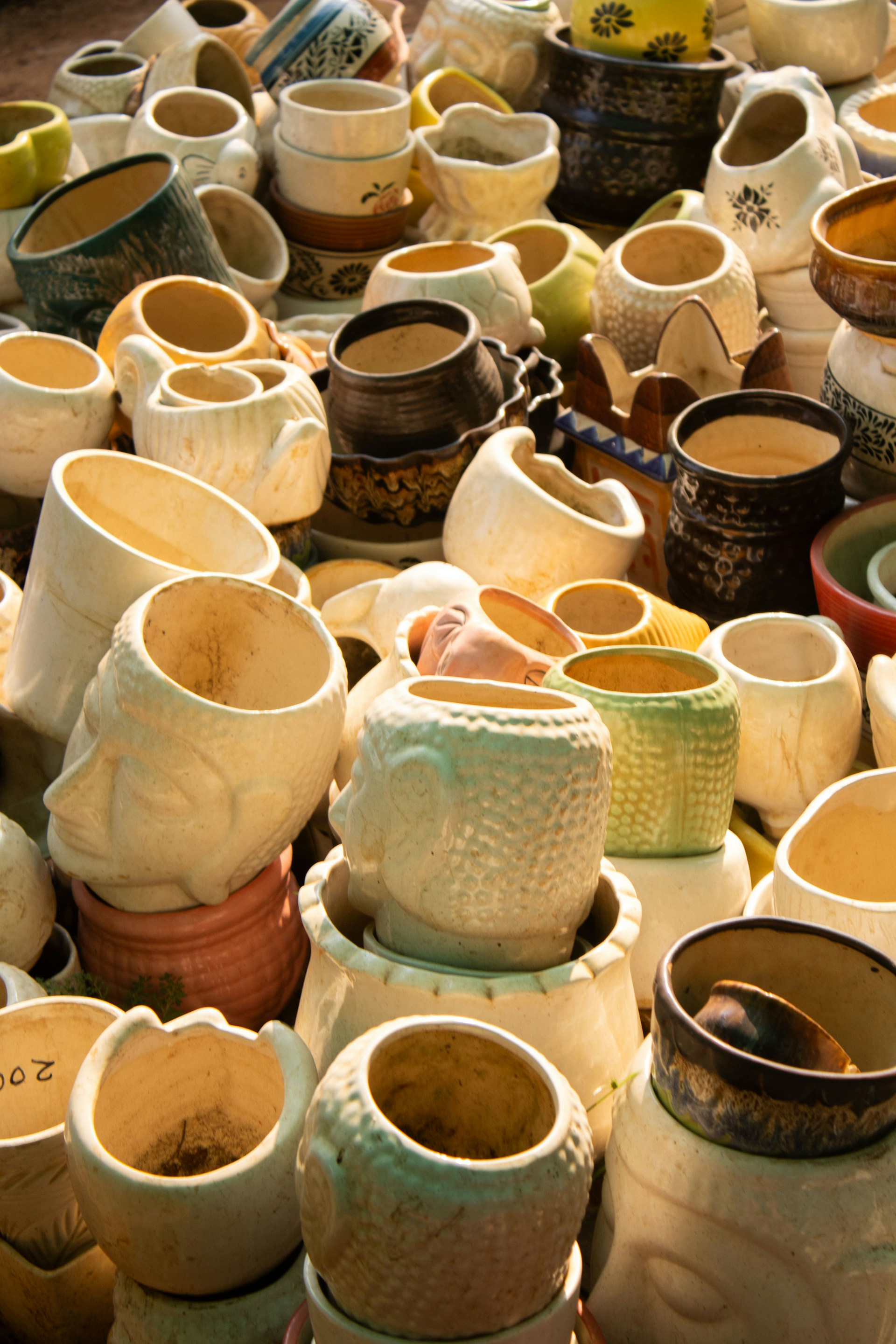a pile of ceramic pots sitting on top of a table