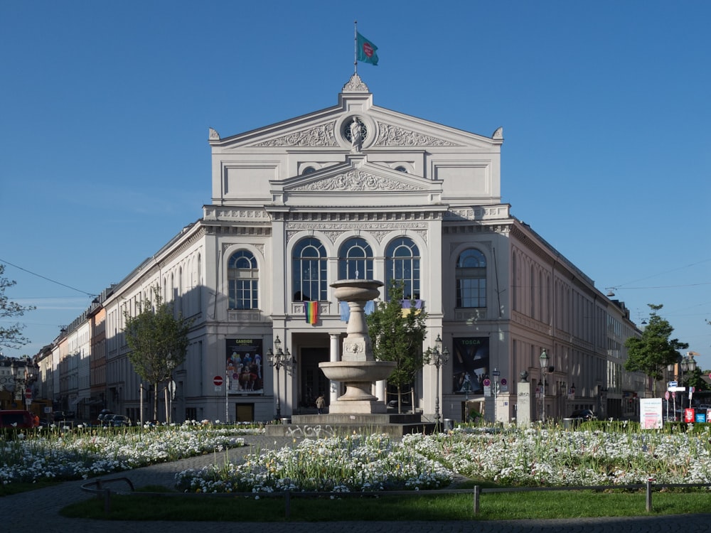 a large building with a fountain in front of it