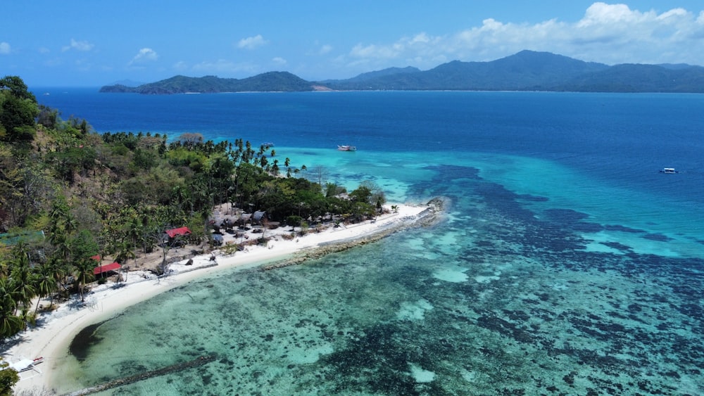 an aerial view of a tropical island with a white sand beach