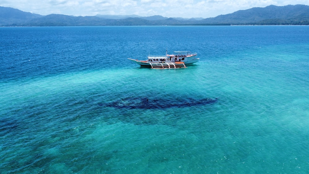 a boat floating on top of a large body of water