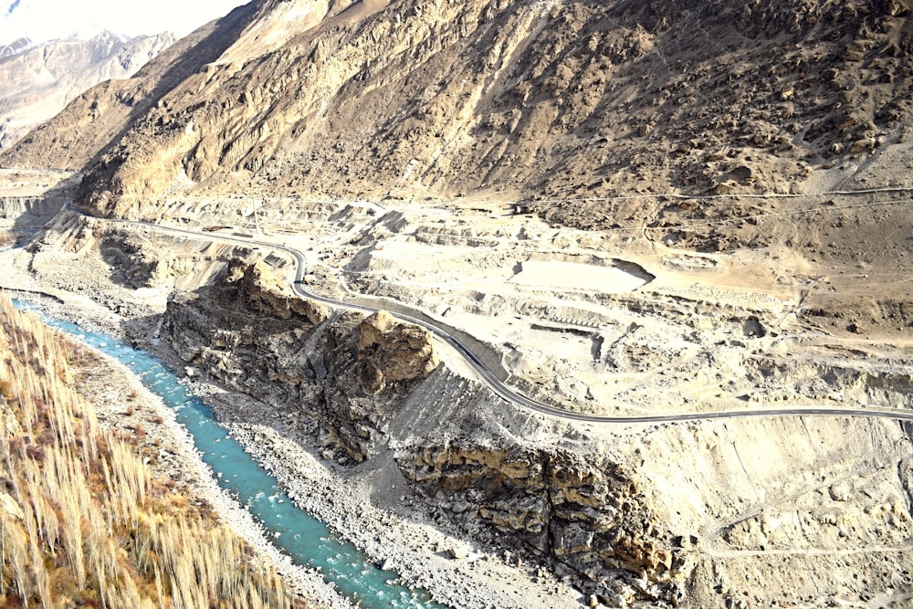 a view of a mountain with a river running through it