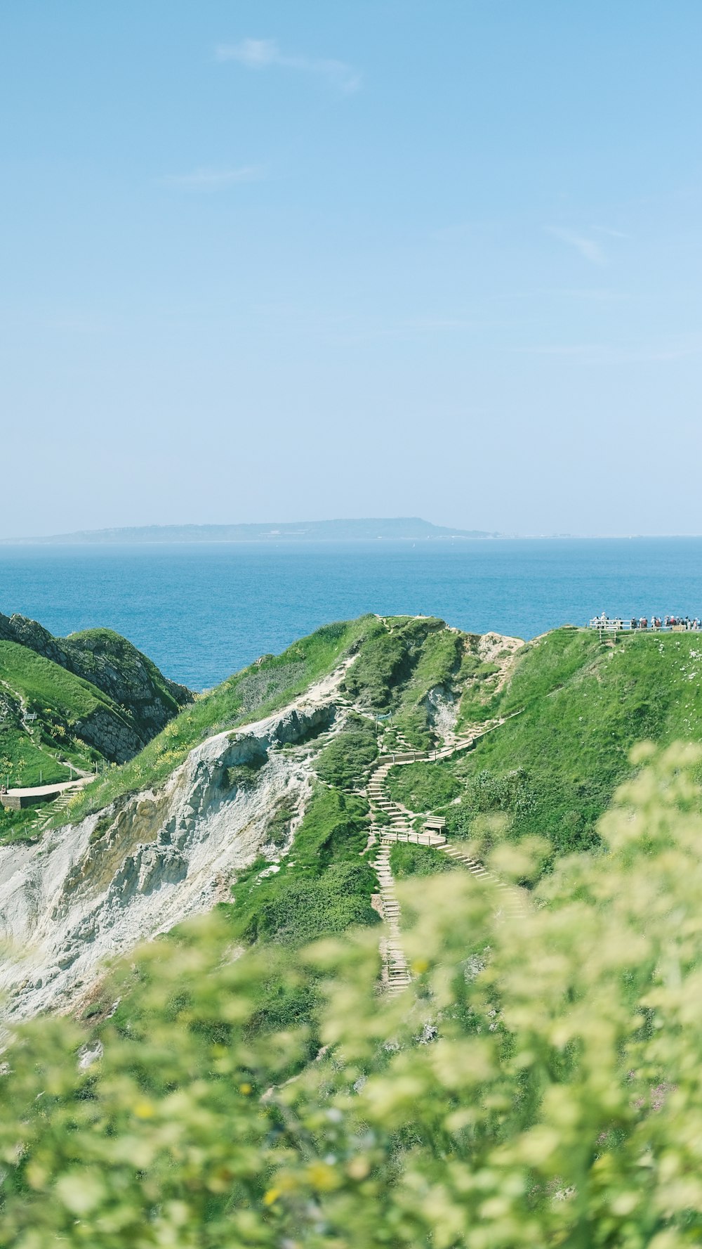 a scenic view of the ocean from the top of a hill