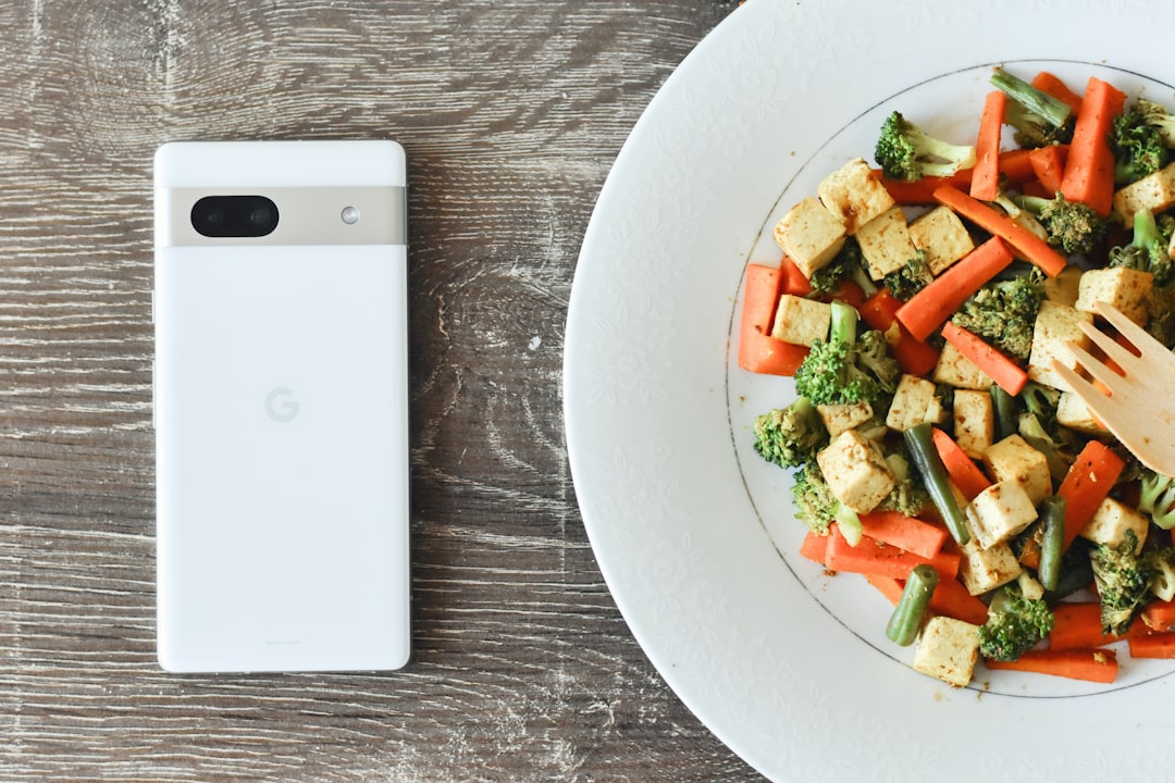 a plate of food with a cell phone next to it,