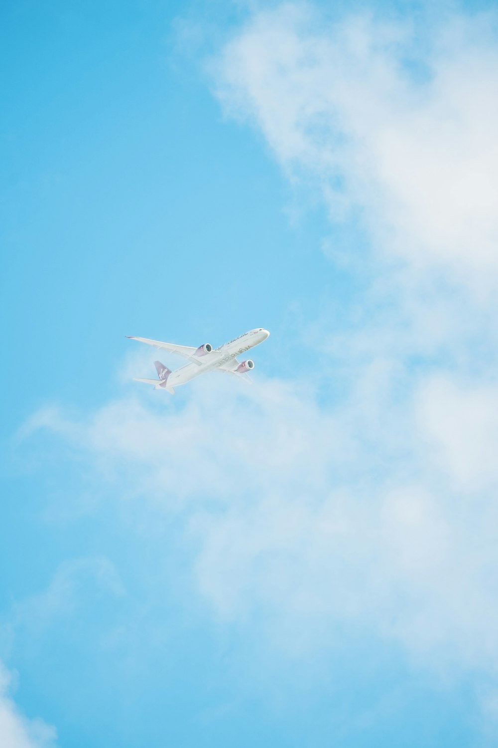 an airplane is flying through the blue sky