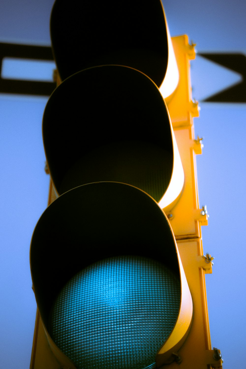 a close up of a traffic light with a sky background