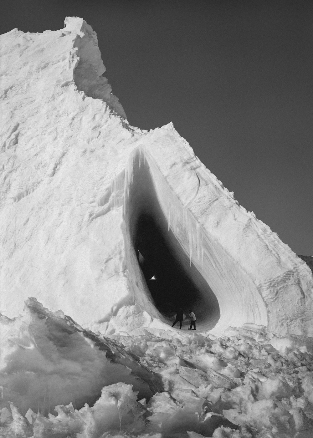 a man is standing in an ice cave