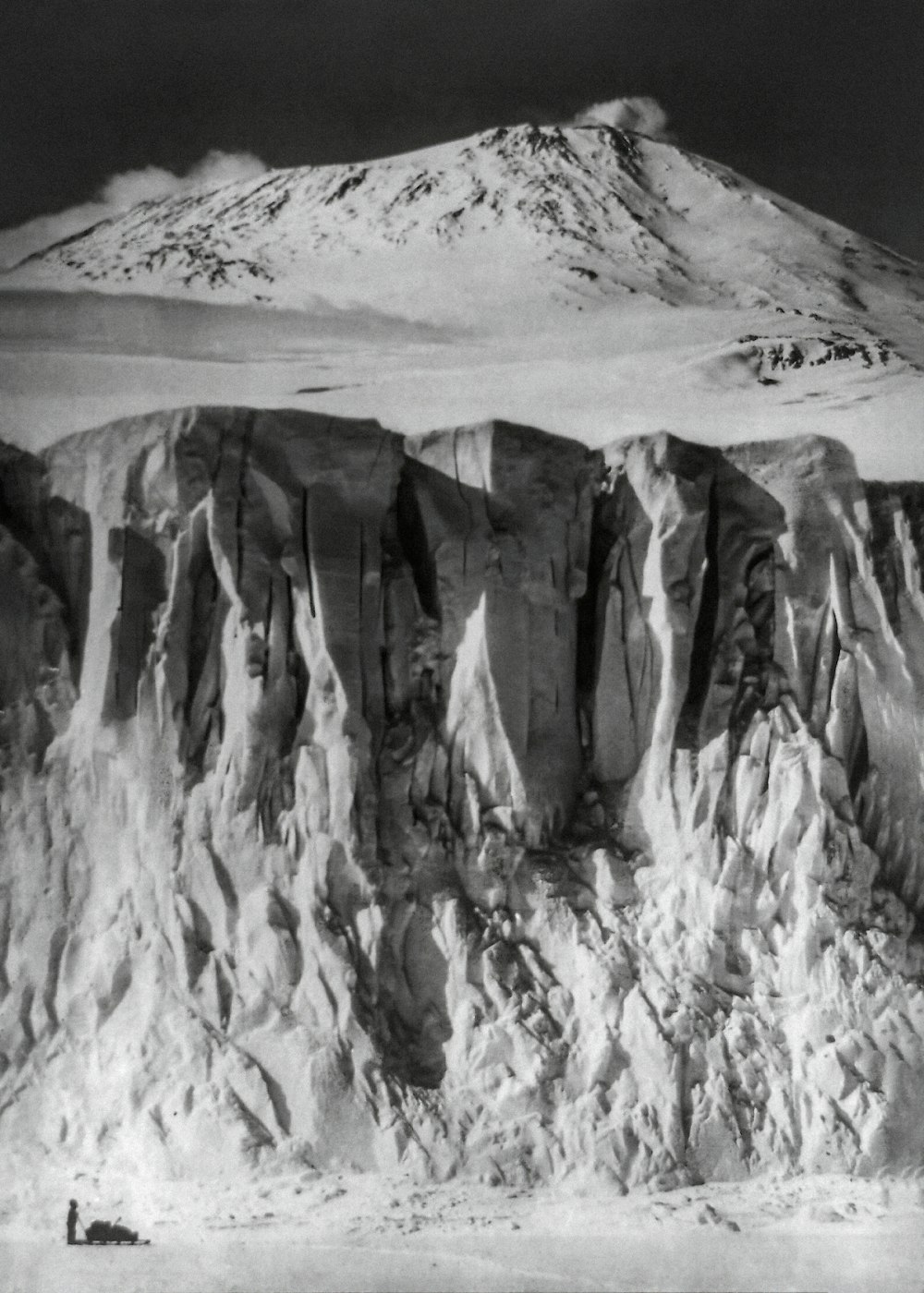 a black and white photo of a snow covered mountain