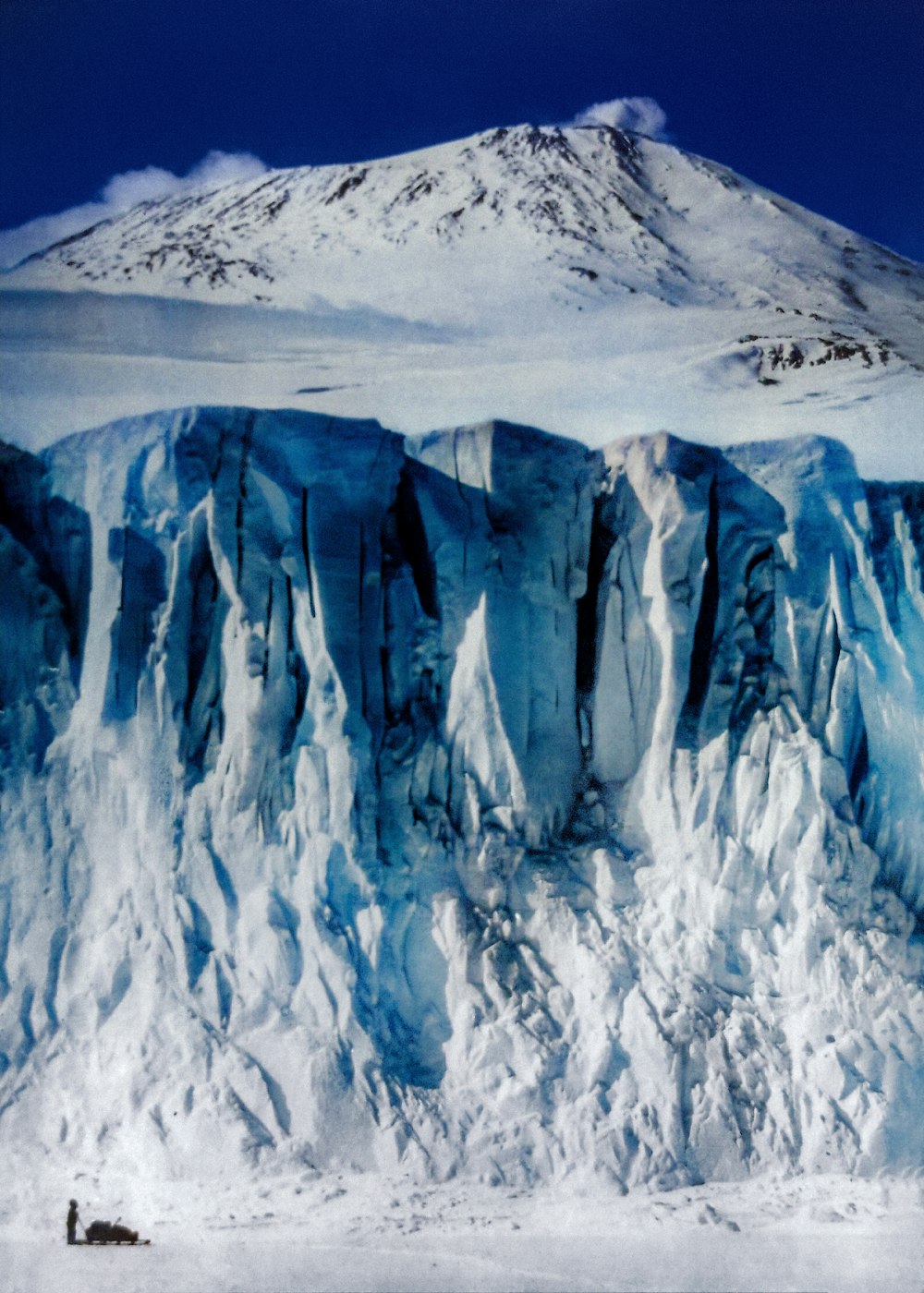 a large glacier with a mountain in the background