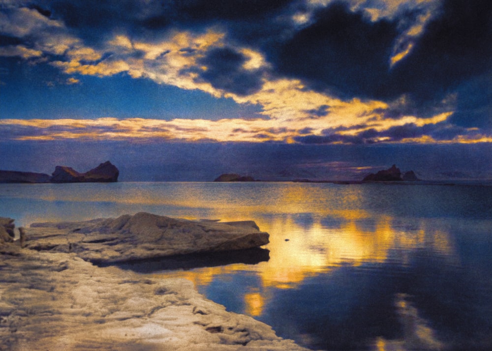 a large body of water under a cloudy sky