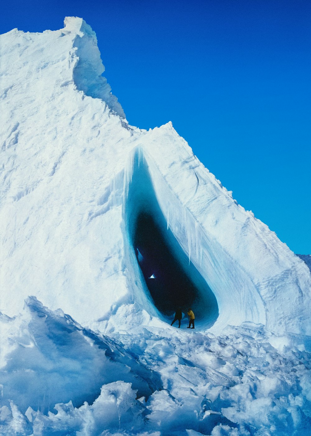 a man standing in the middle of an ice cave