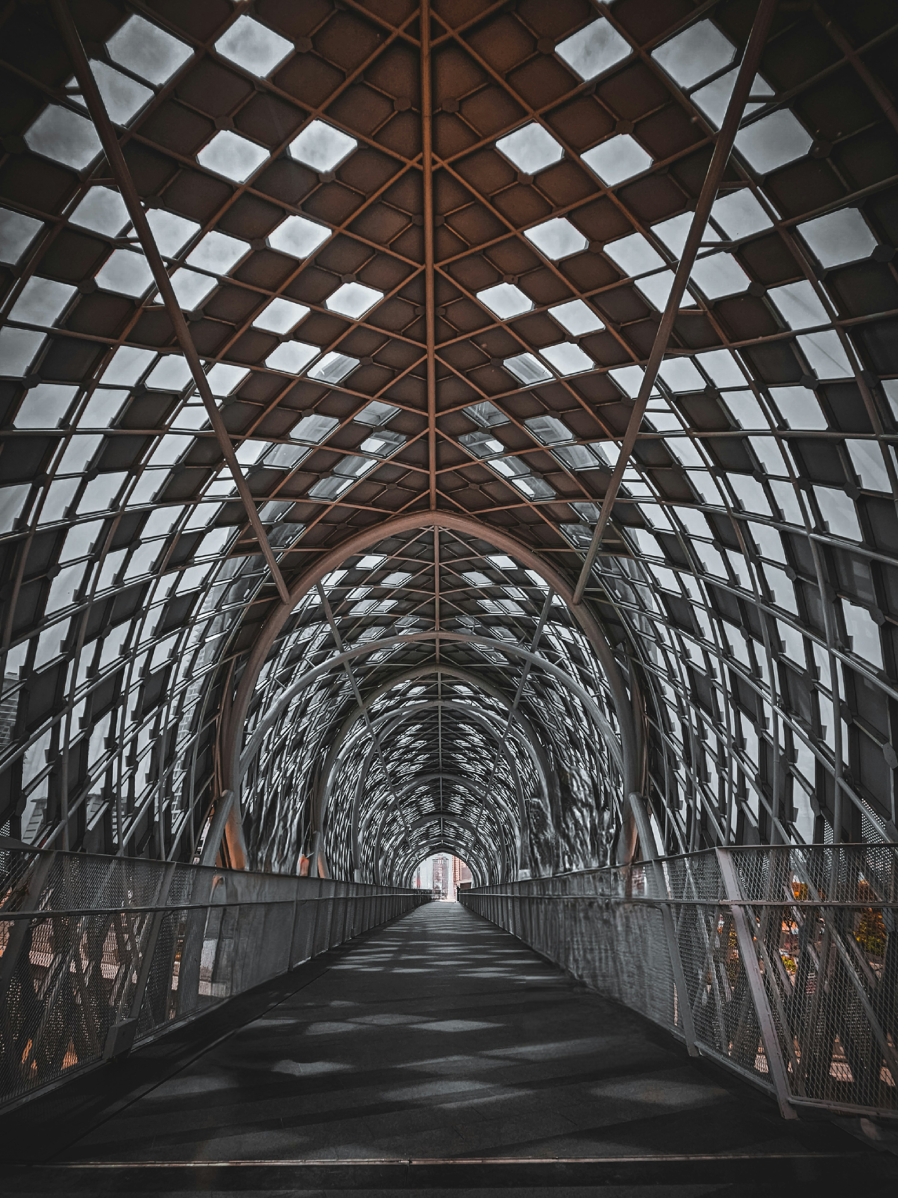 a walkway that has a metal structure over it