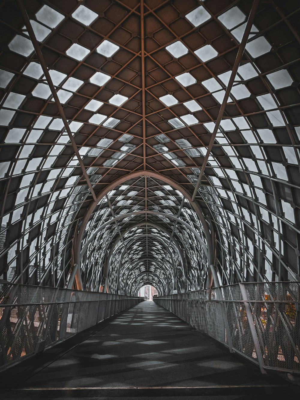 a walkway that has a metal structure over it