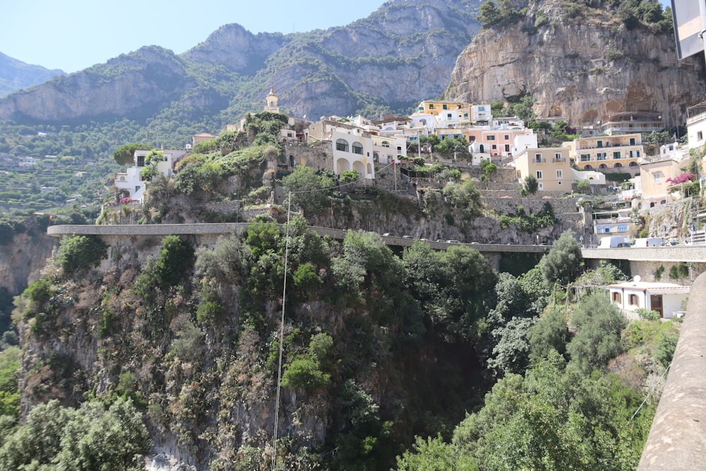 a scenic view of a town on a cliff