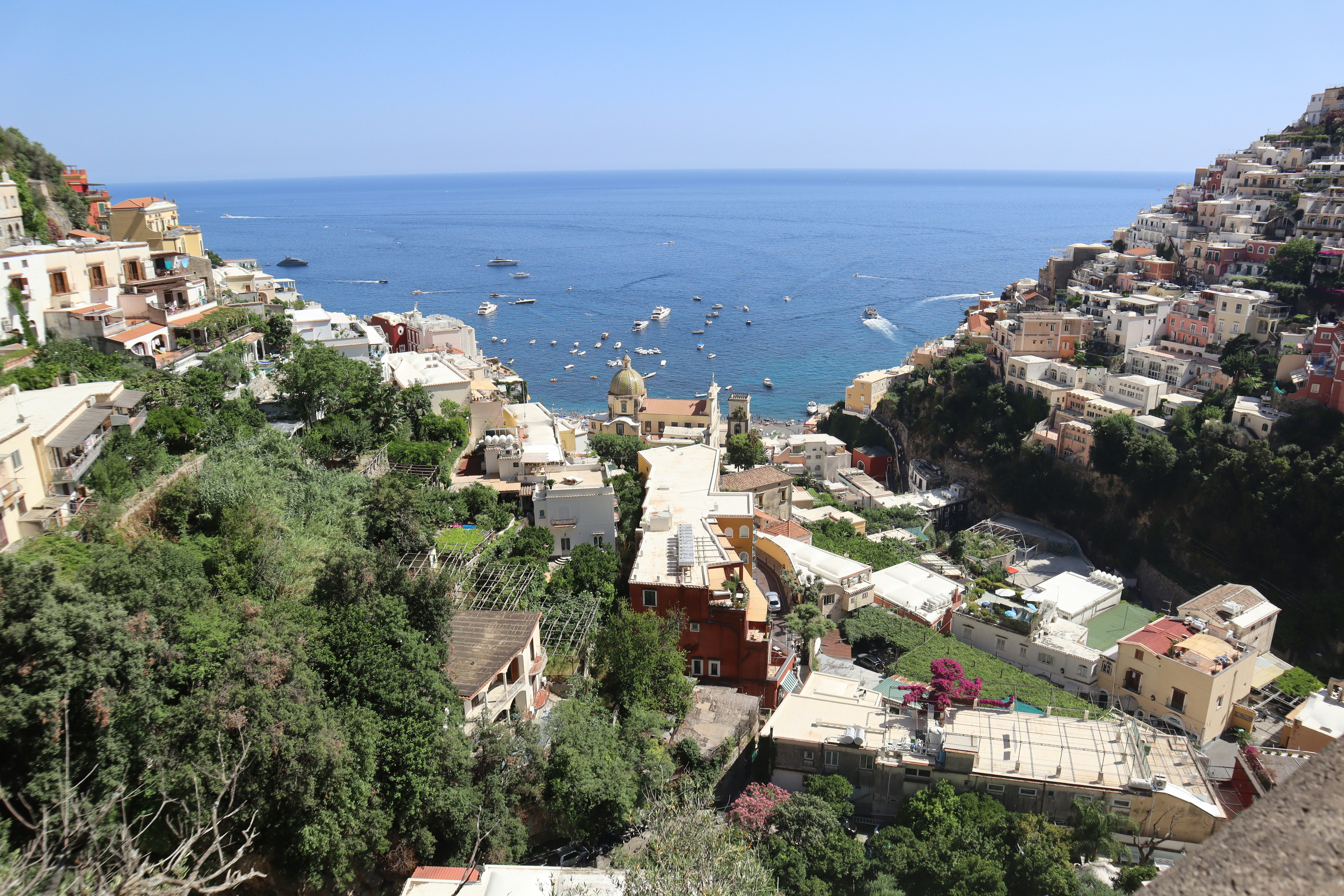 a scenic view of a city next to the ocean