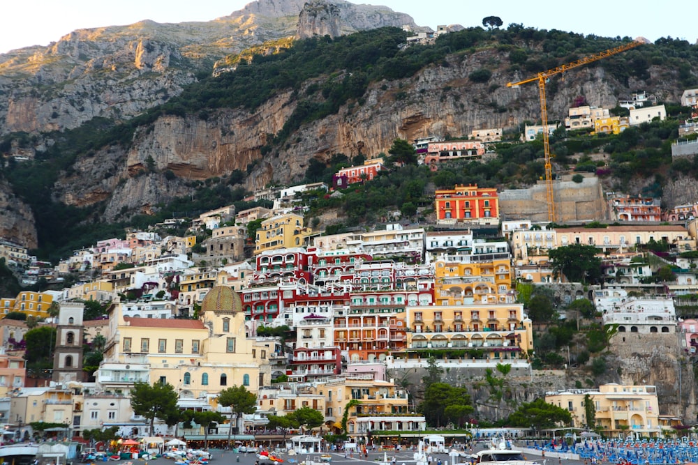 a city on the side of a mountain covered in lots of buildings