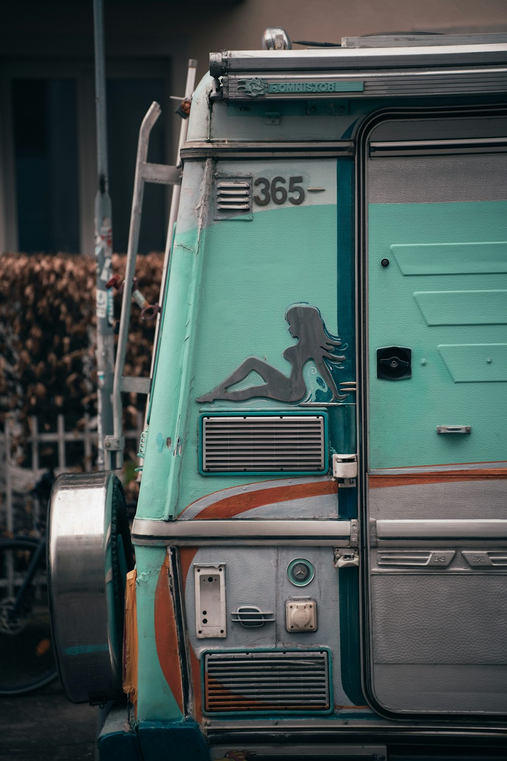 a blue bus with a picture of a woman on it