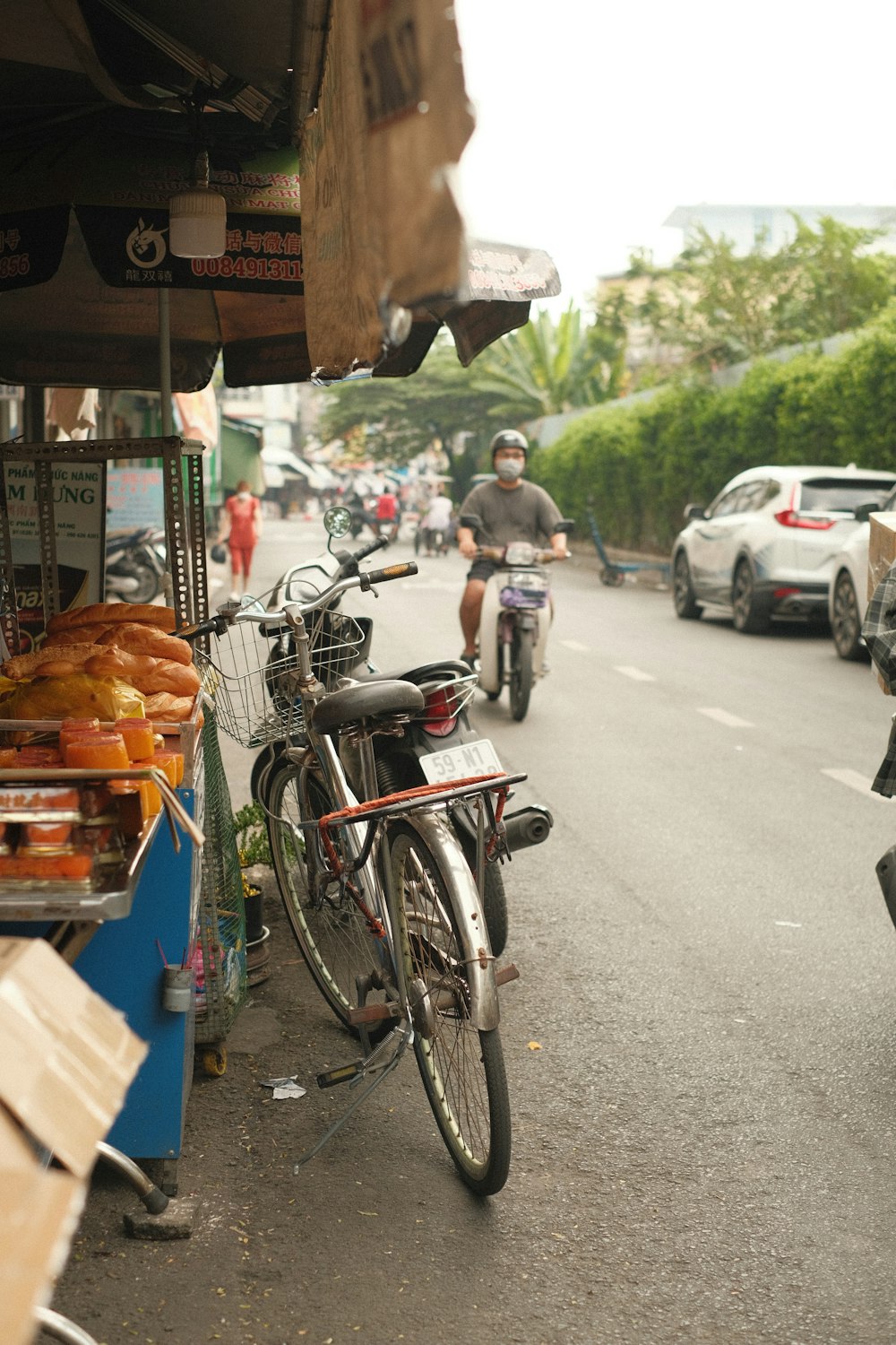 a bicycle parked next to a food stand