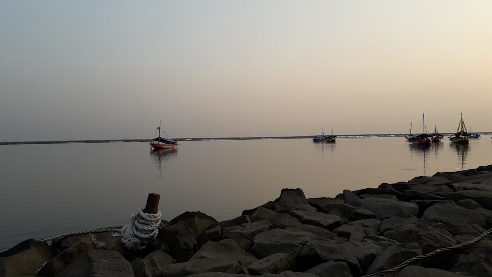 a group of boats floating on top of a body of water