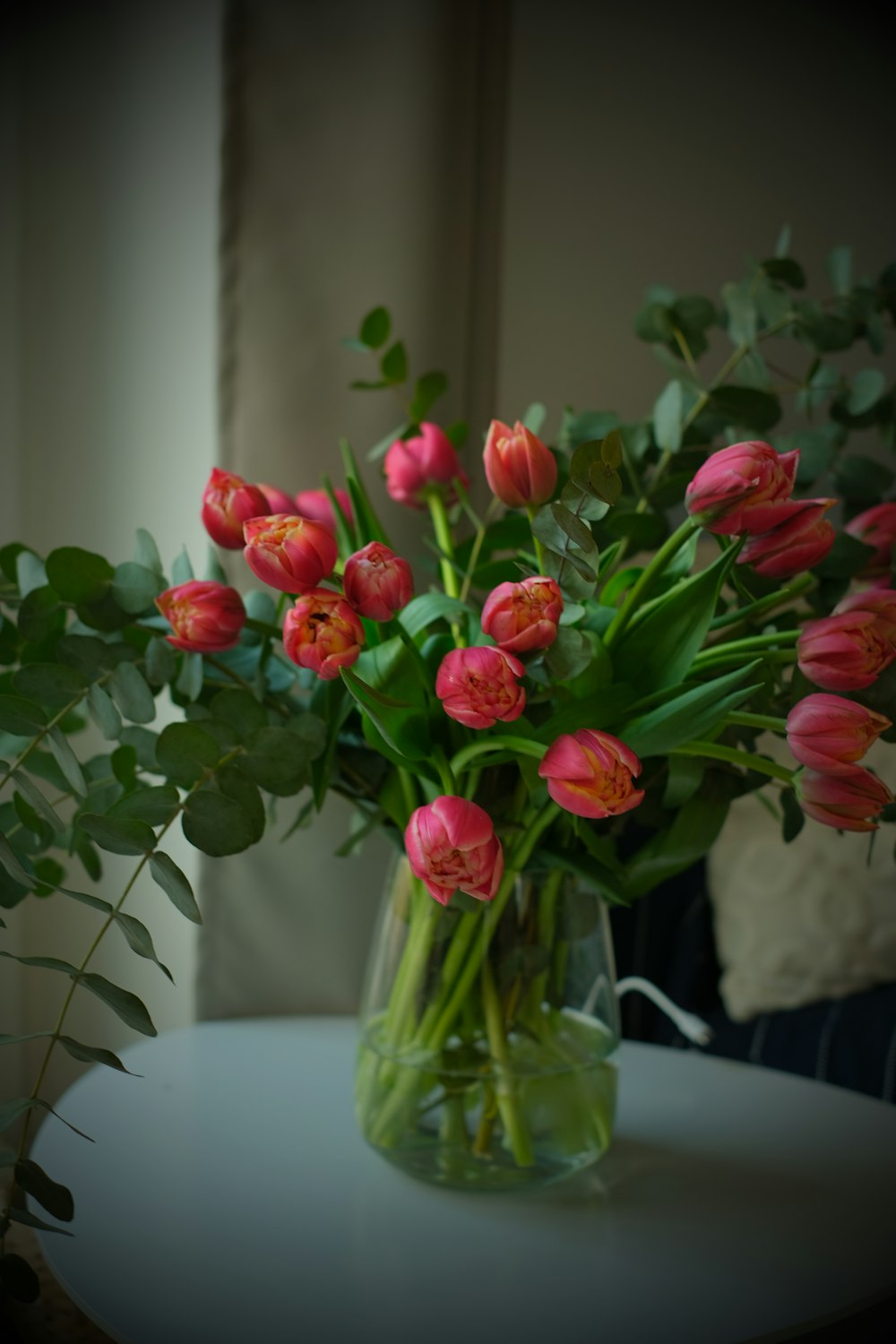 a vase filled with pink flowers on top of a table