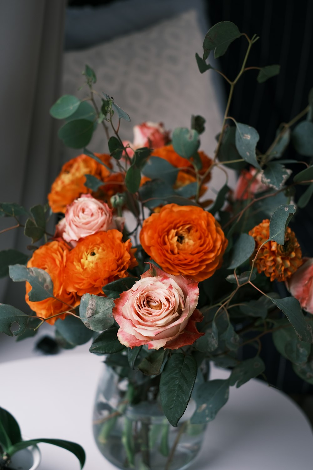 a vase filled with orange and pink flowers
