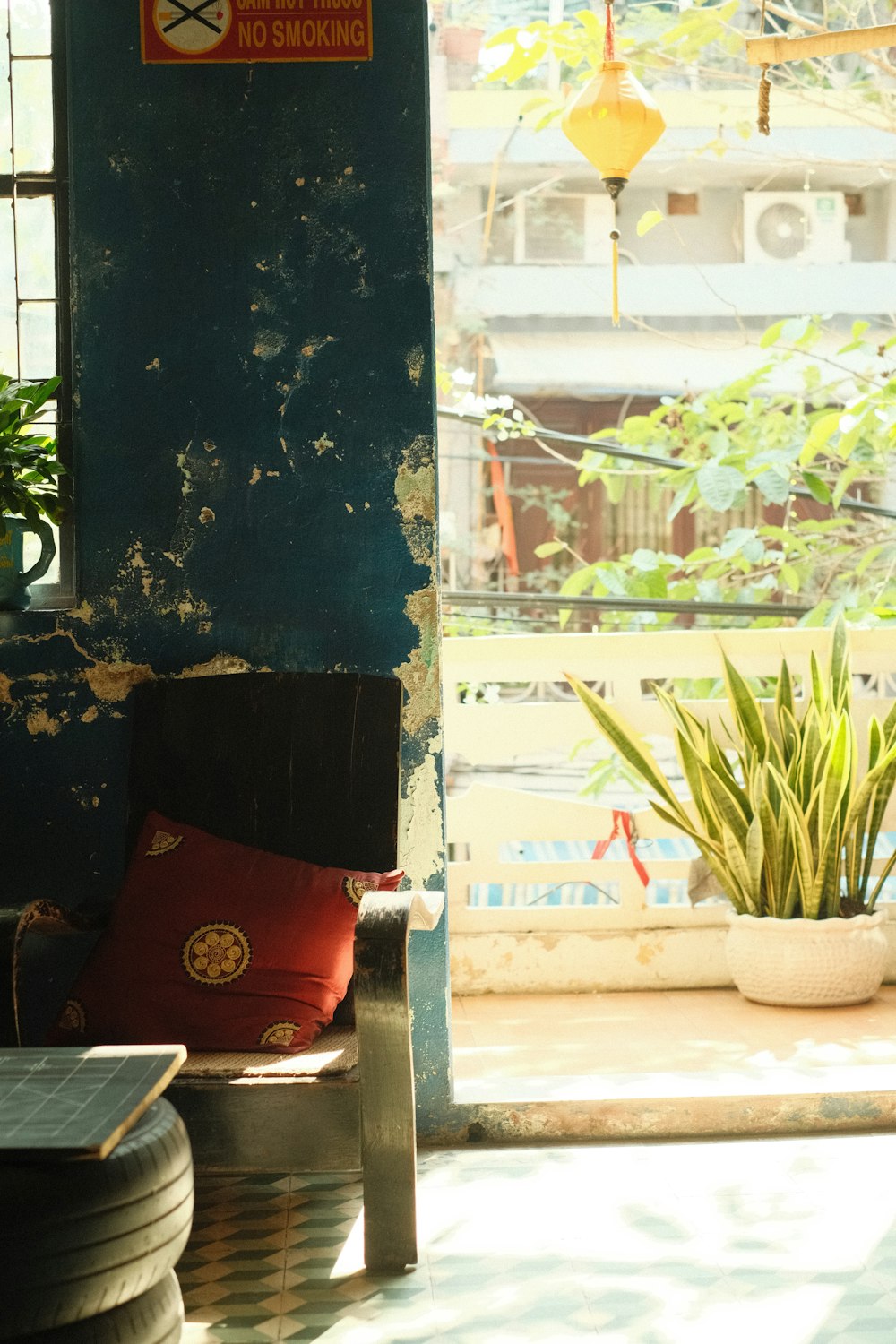 a room with a potted plant and a no smoking sign