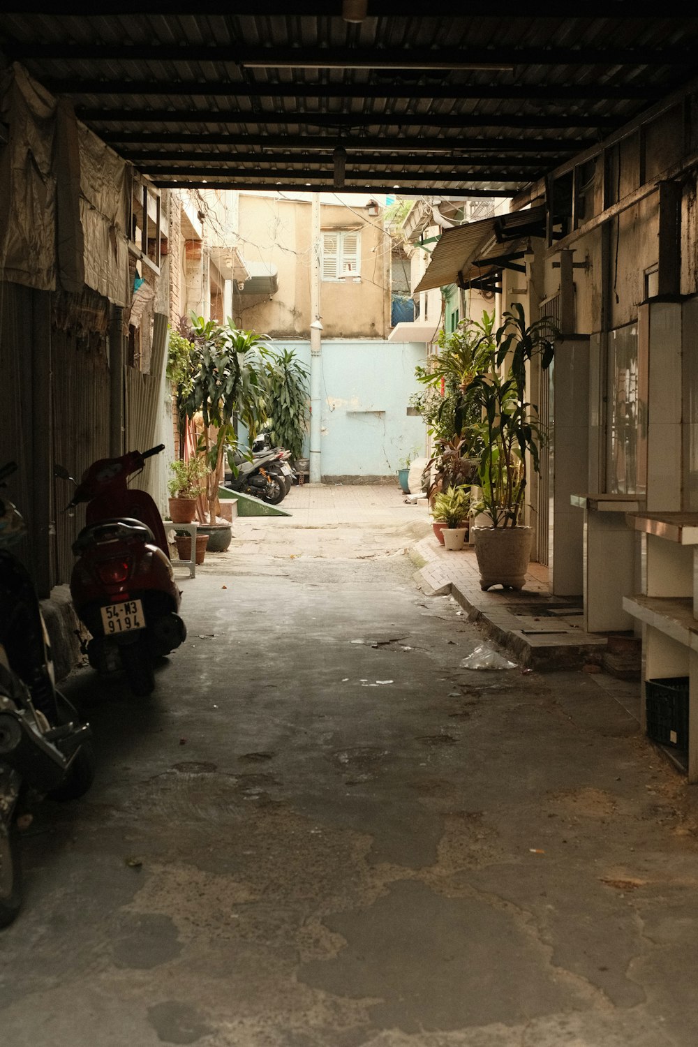 a motorcycle is parked in a narrow alley