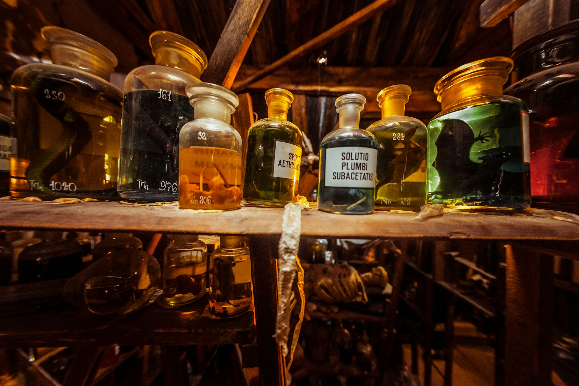 a shelf filled with lots of bottles of liquid